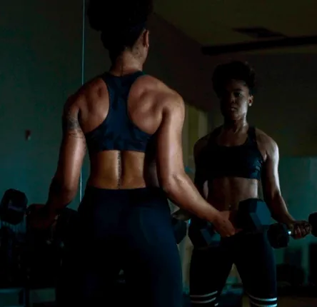 Two women training with dumbbells — define your fitness goals at The A Team Women's Fitness