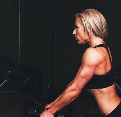 Woman lifting dumbbells at women-only gym in Dunnellon Florida