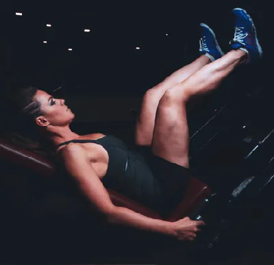 Woman using leg press machine at The A Team Women's Fitness gym in Dunnellon FL